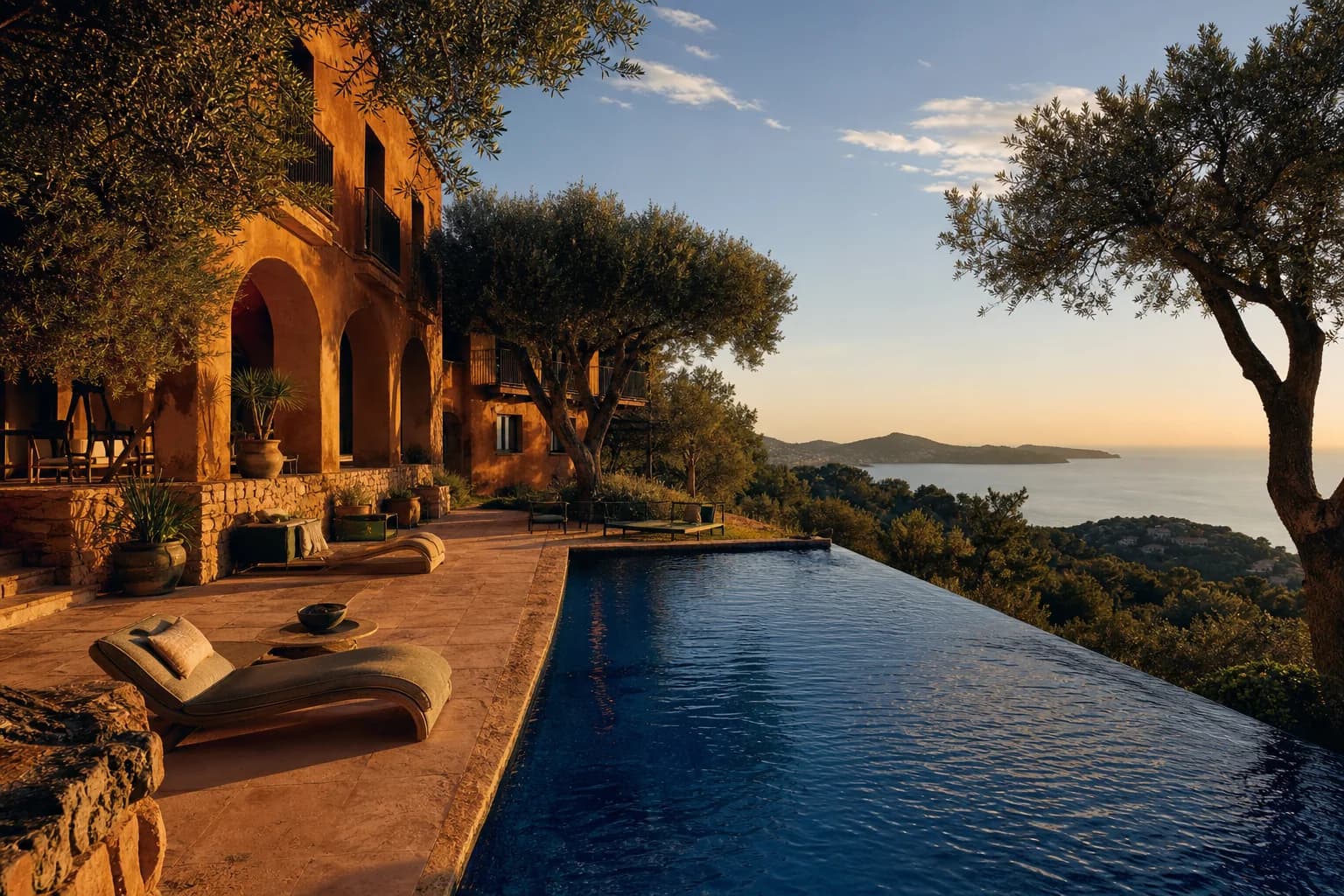A terracotta Mediterranean retreat and cobalt pool overlooking the Spanish coast at sunset